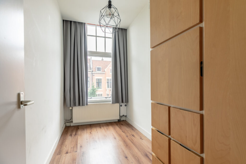 Minimalist room with wooden floor and window view