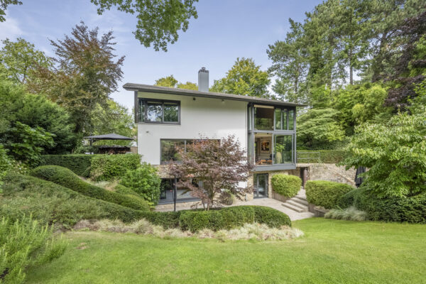 Modern house surrounded by lush green garden