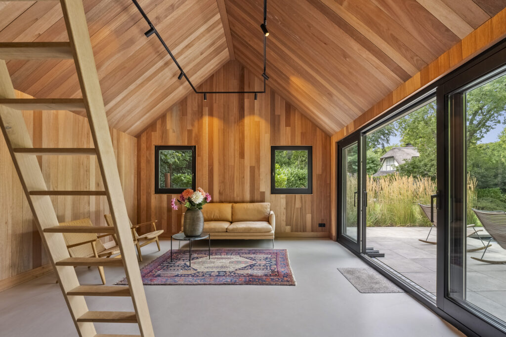 Cozy wooden interior with modern furniture and glass doors.