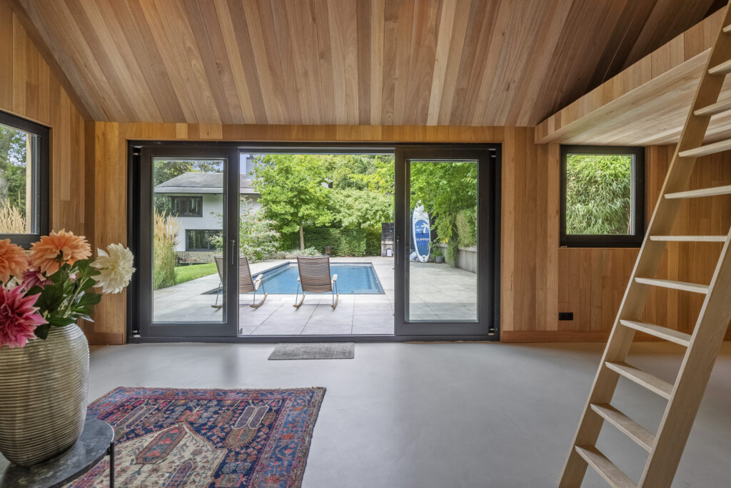 Modern room with pool view and wooden interior.