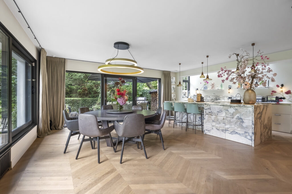 Modern dining area with marble kitchen island.