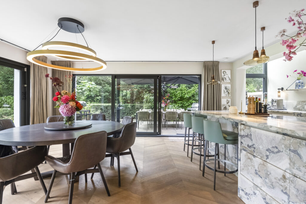 Modern kitchen with stylish dining area and decor.