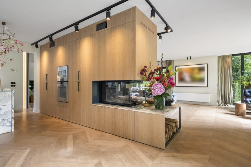 Modern living room with wooden cabinetry and fireplace.