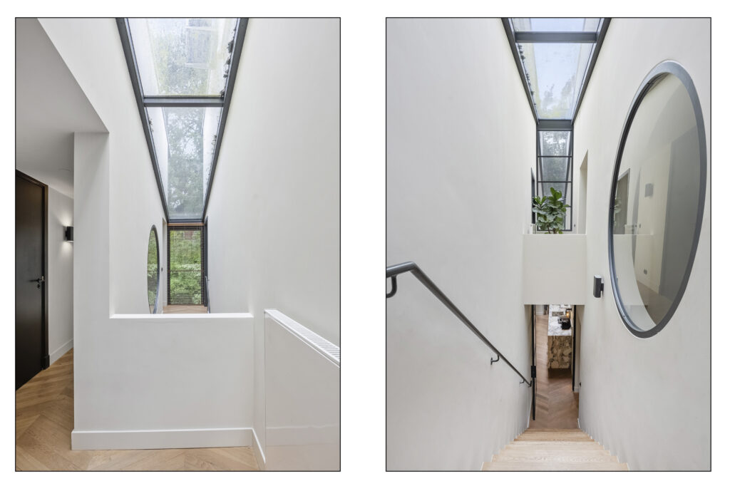 Modern hallway with skylight and wooden stairs