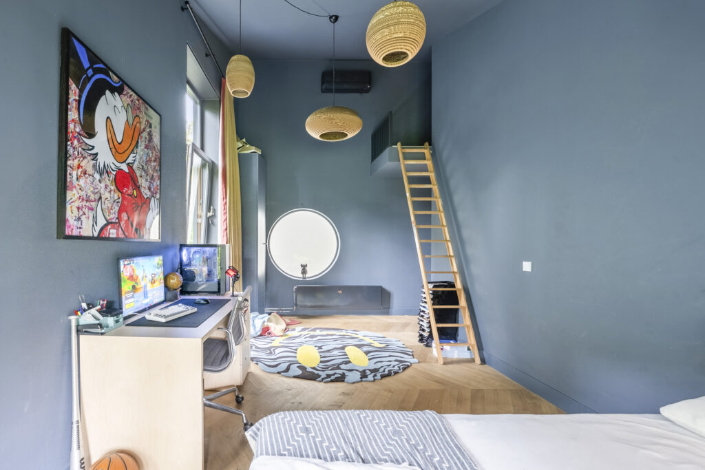 Modern room with desk, bed, and ladder