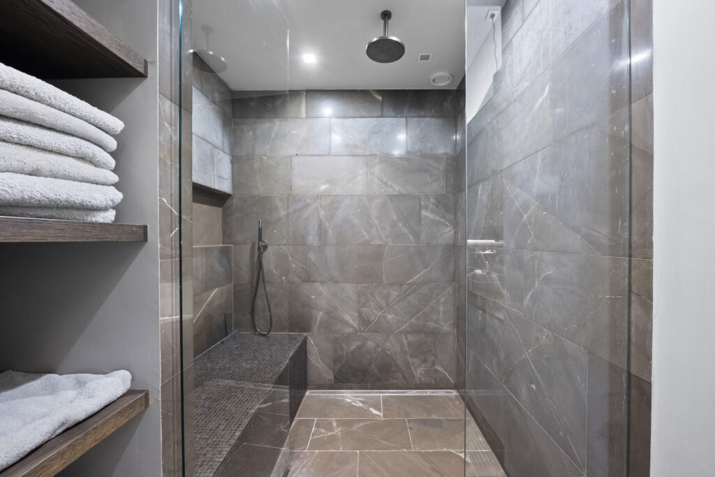 Modern bathroom with sleek tile design and rain shower.