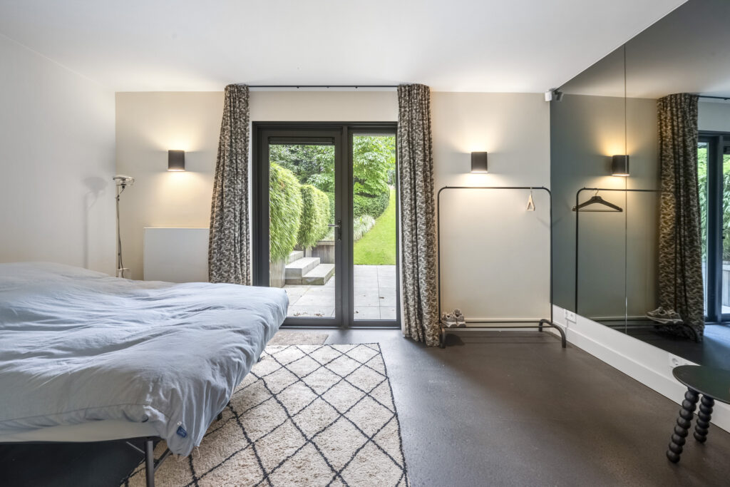 Modern bedroom with garden view door.