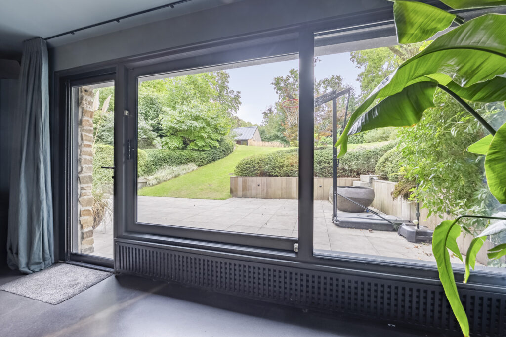View of garden through large glass doors.