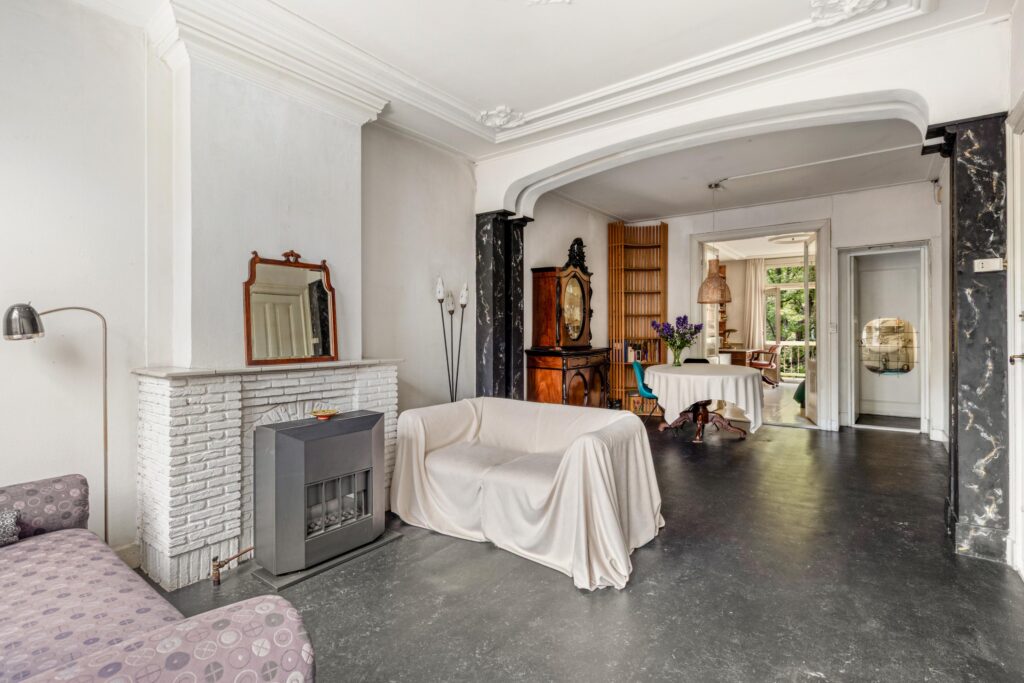 Elegant living room with fireplace and dining area.