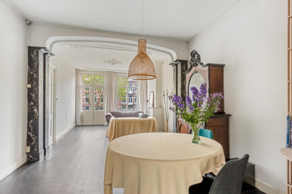 Elegant living room with flowers and ornate furniture.