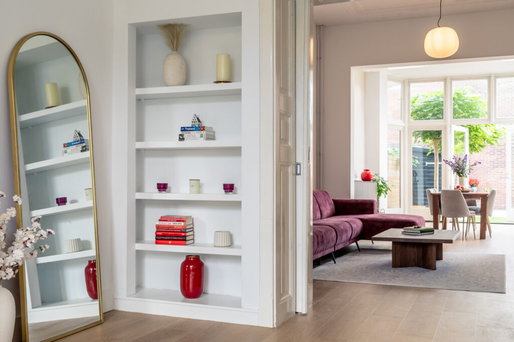 Modern living room with bookshelf and mirror.