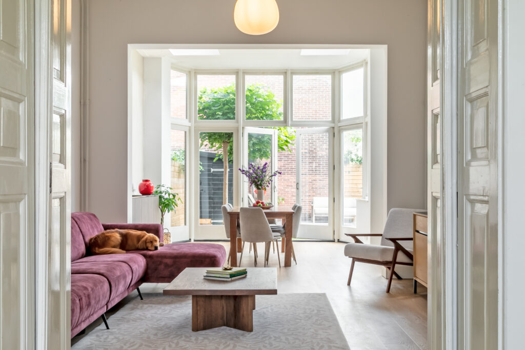 Cozy living room with sofa and dining area.