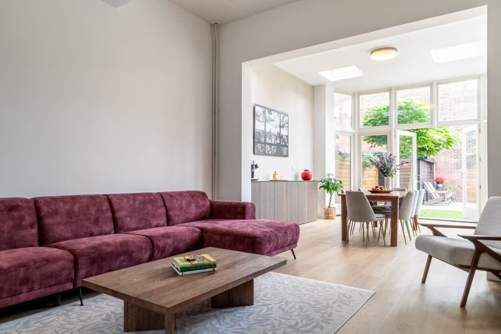 Modern living room with large windows and sofa.