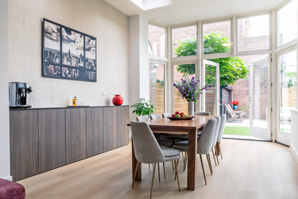 Modern dining room with large windows and table.