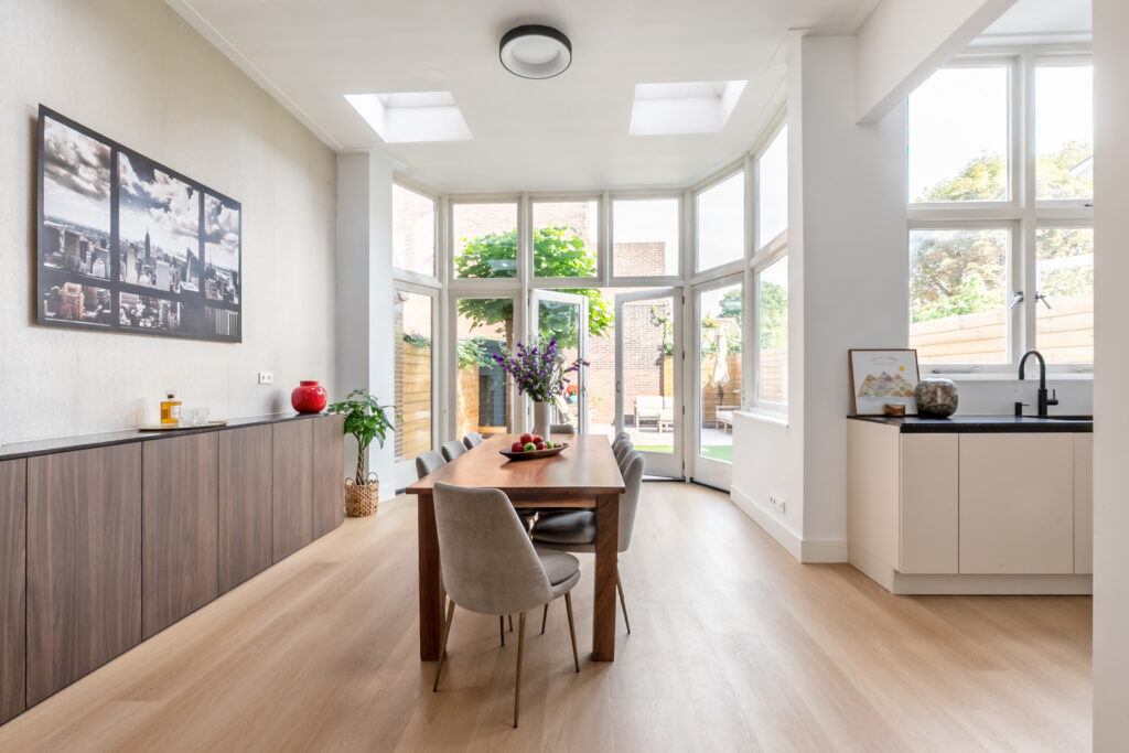 Bright dining room with large windows and modern decor.