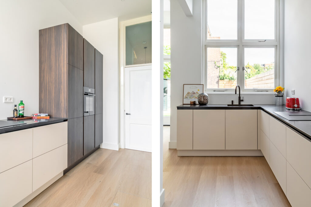 Modern kitchen with wooden cabinets and large windows.