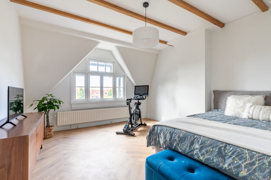 Bedroom with exercise bike and large window