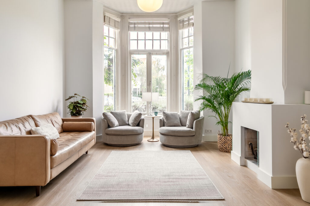 Modern living room with beige furniture and plants.