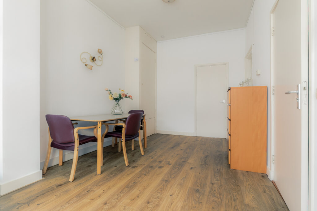 Minimalist dining area with table and chairs.