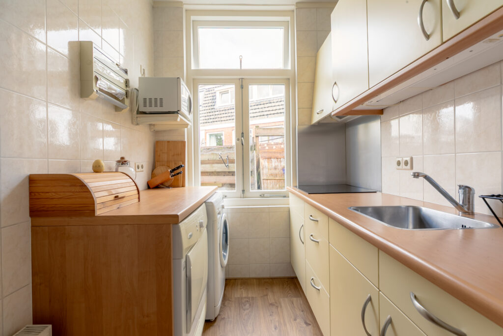 Modern kitchen with wooden countertops and appliances.