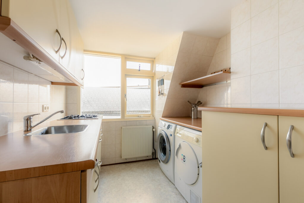 Modern kitchen with appliances and wooden countertops.