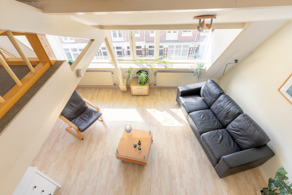 Aerial view of sunny living room with sofas.