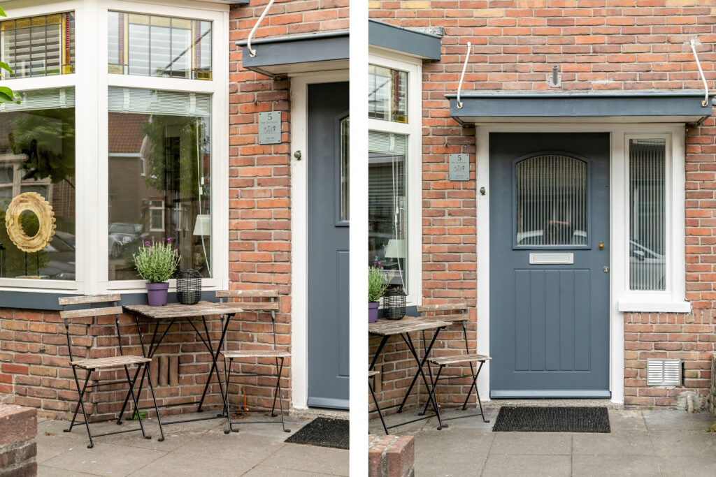 Cozy patio with table, chairs, and blue door.