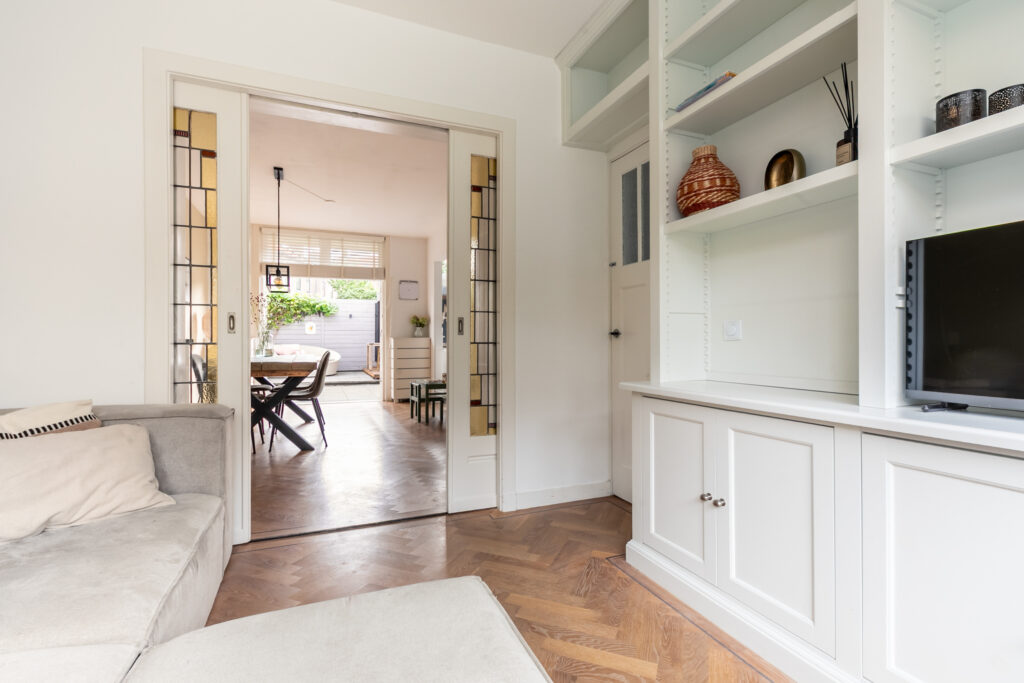 Open-plan living room with dining area and bookshelf