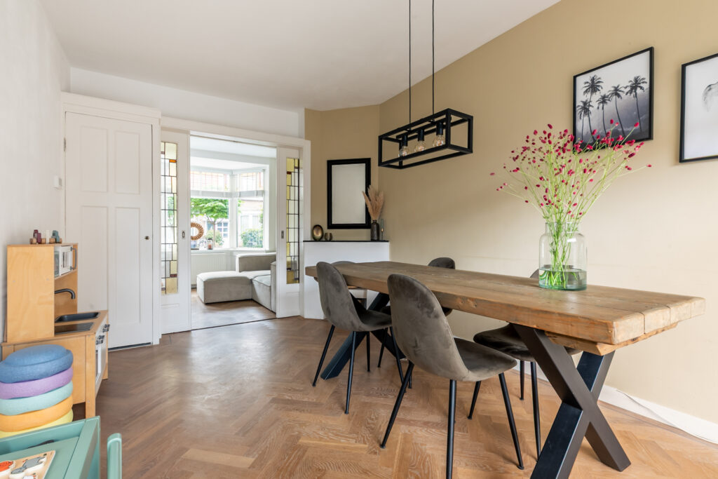 Modern dining room with wooden table and chairs.