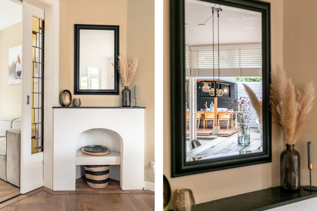 Cozy living room with decorative mirror and vases.