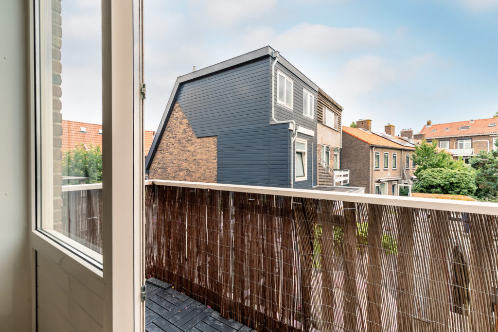 Open balcony view of residential neighborhood homes.