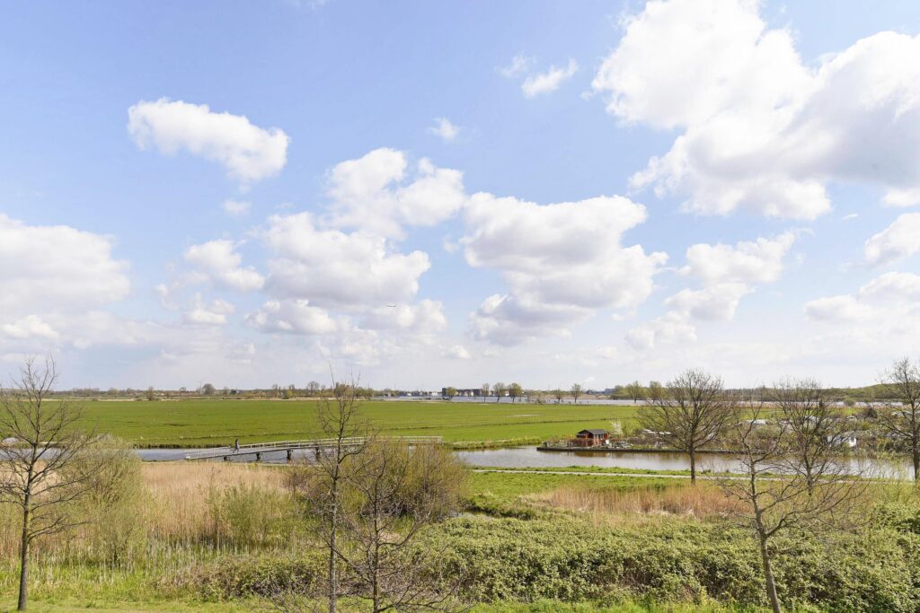 Scenic countryside view with blue sky and clouds.