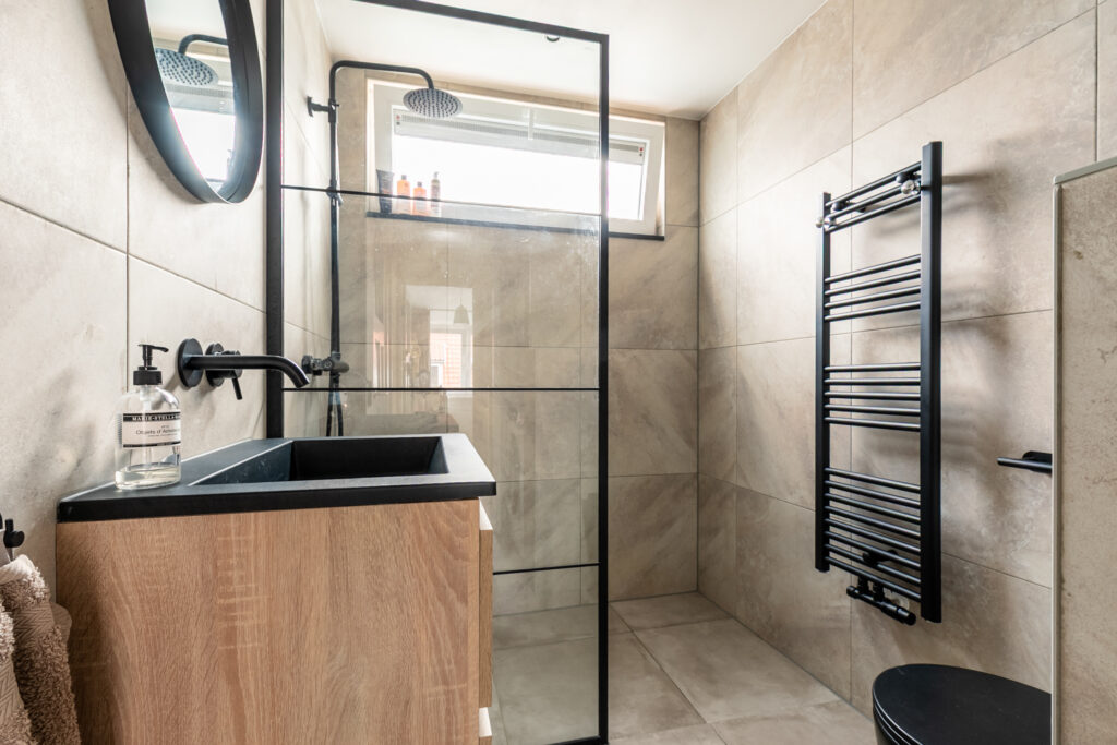 Modern bathroom with black fixtures and glass shower