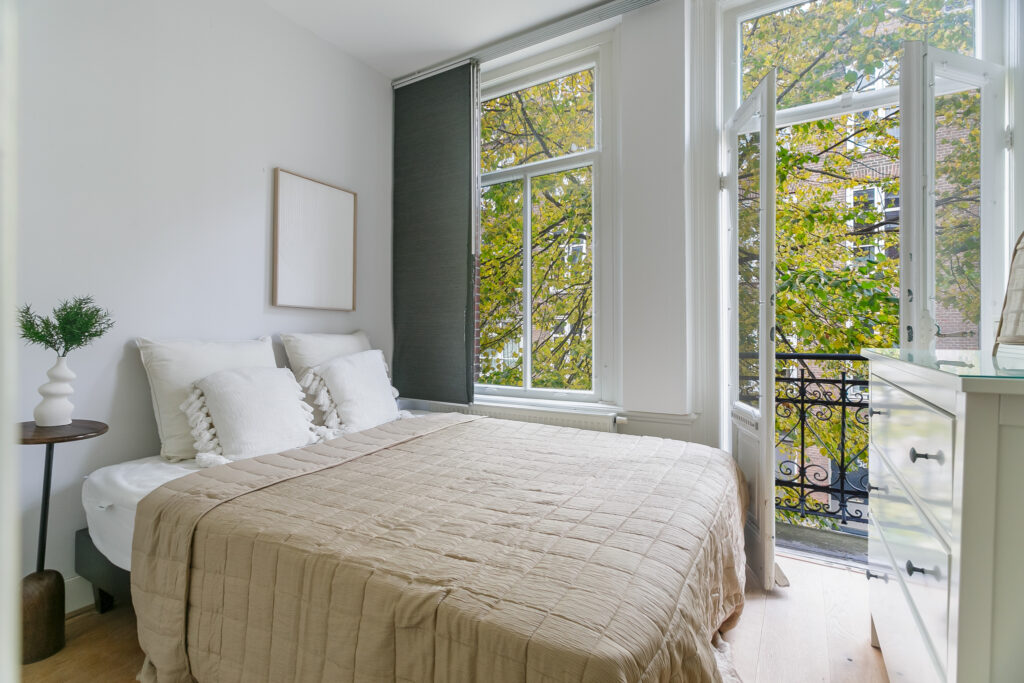 Cozy bedroom with balcony and autumn view
