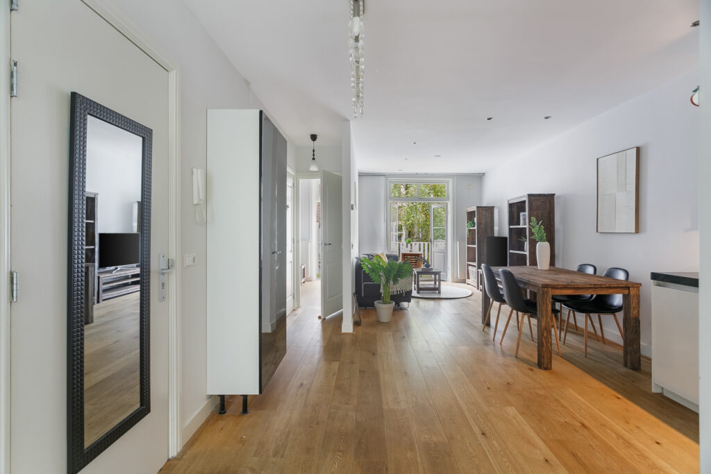 Modern dining area with wooden table and chairs.