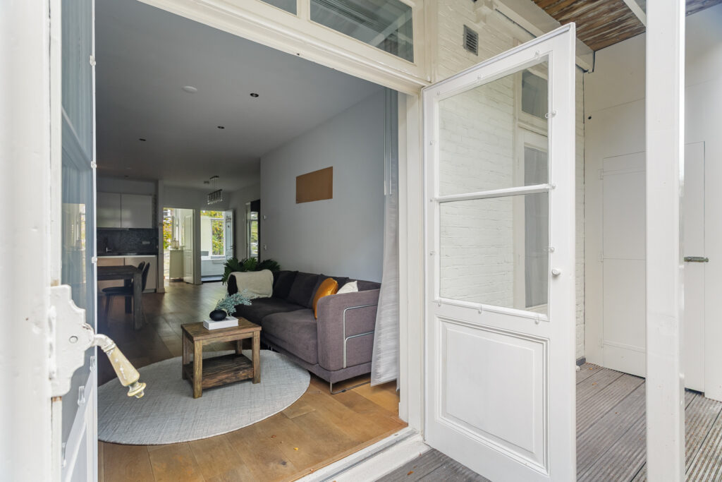Cozy living room visible through open door.