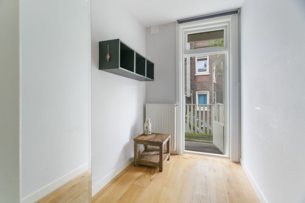 Small room with open door to balcony.