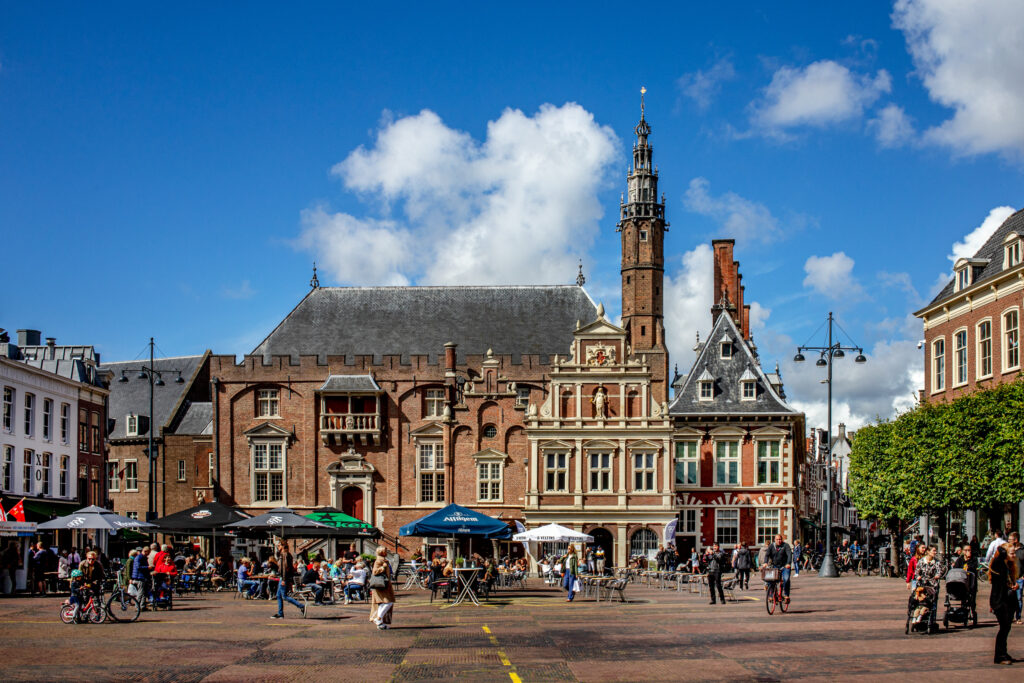 Historic European town square bustling with people and cafes.