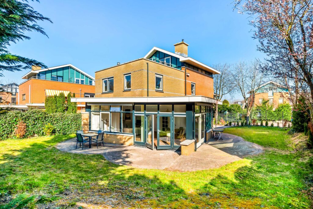 Modern brick house with large windows and garden