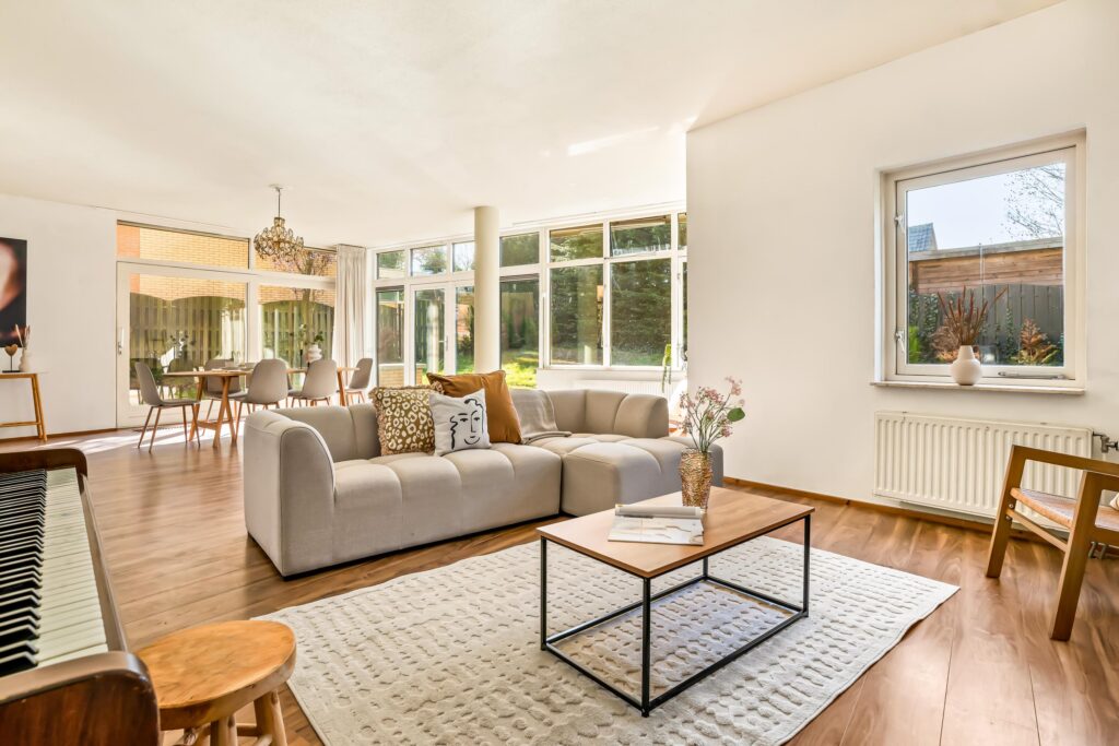 Bright modern living room with large windows and piano.