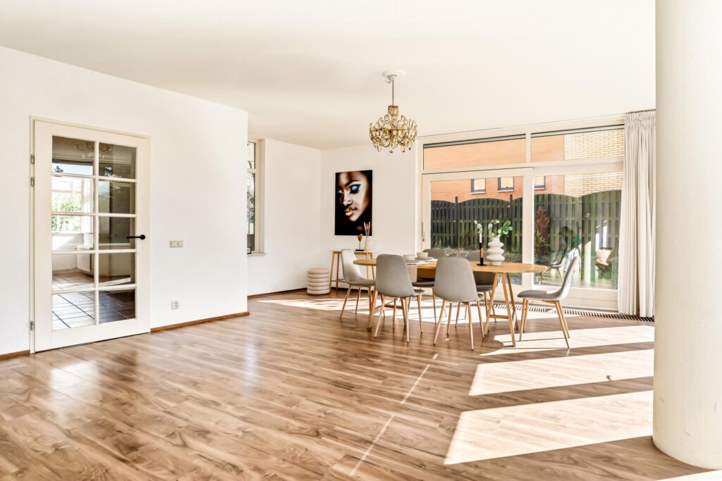 Spacious dining room with modern furniture and large windows.