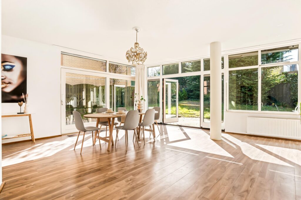 Spacious dining room with natural light and garden view.