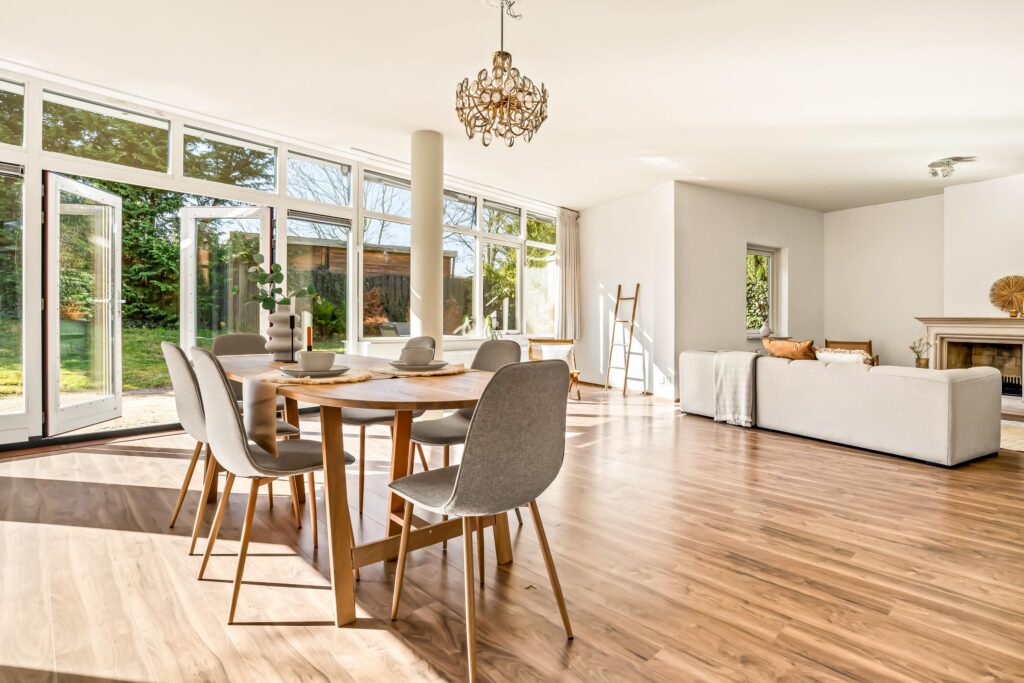Spacious living room with dining area and large windows.