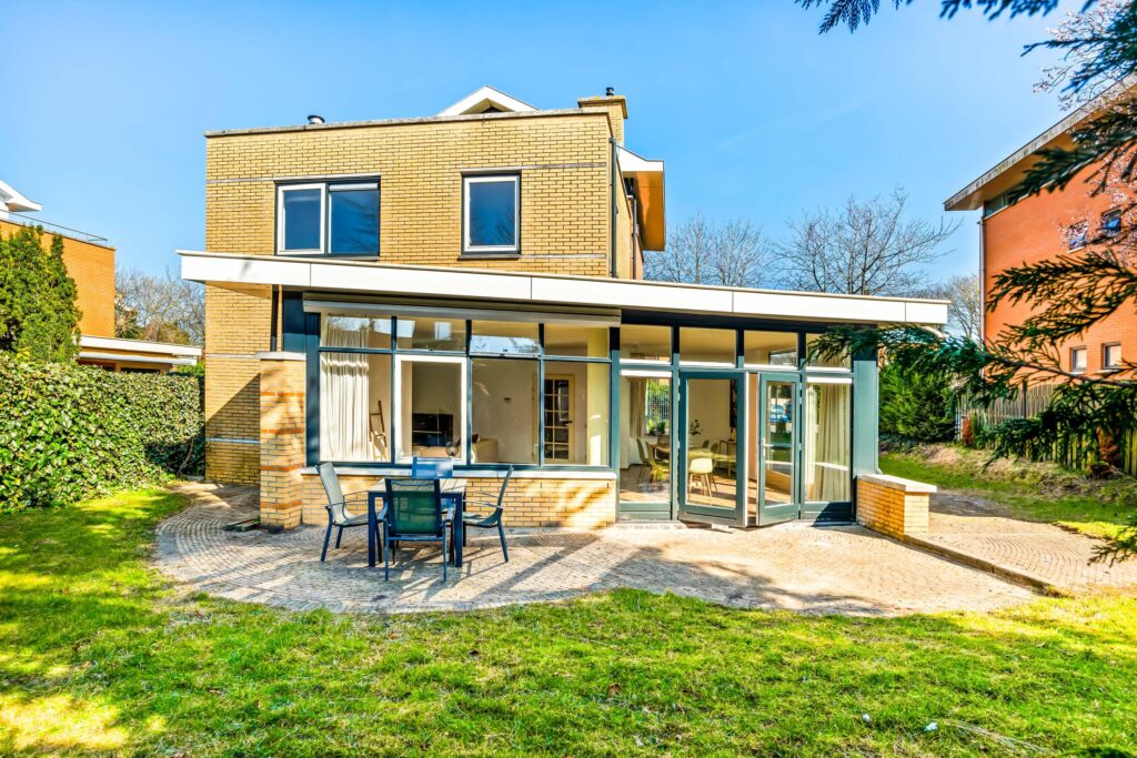 Modern house with patio and large windows.