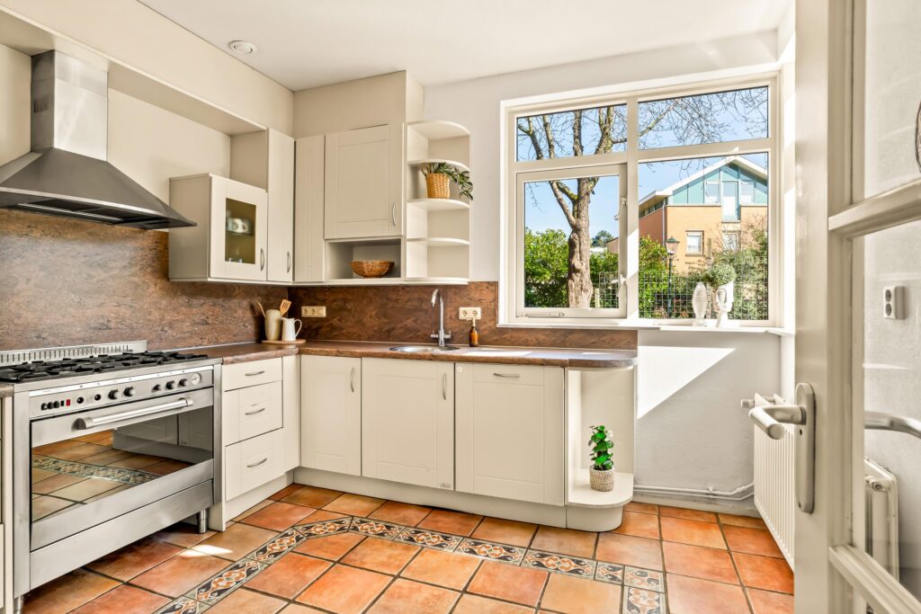 Bright kitchen with modern appliances and tiled floor.