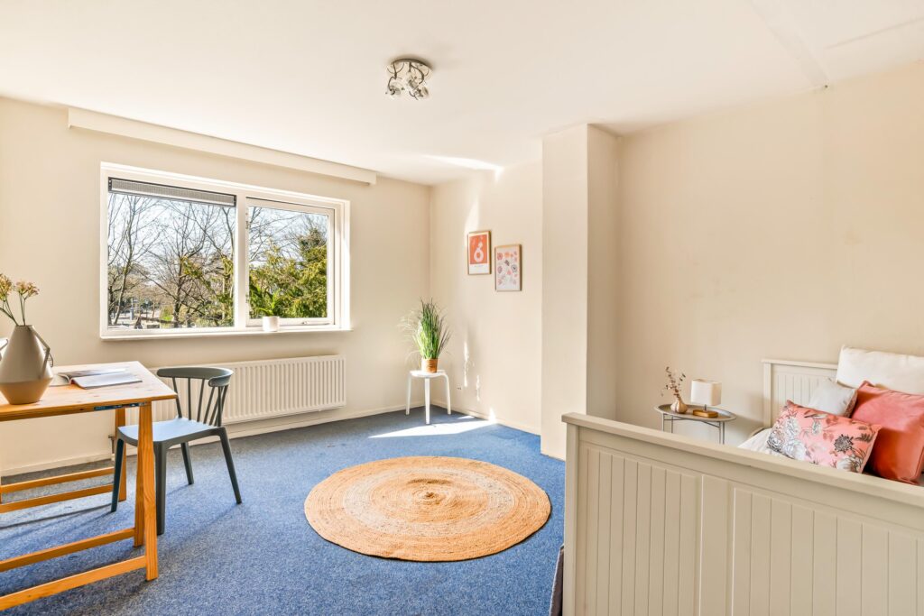 Bright room with table, chair, window, and decor.
