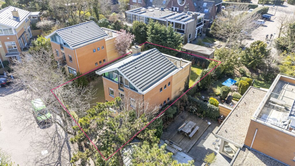 Aerial view of house and garden in neighborhood.