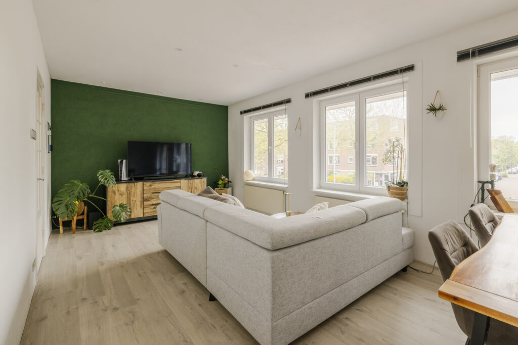 Modern living room with green accent wall.