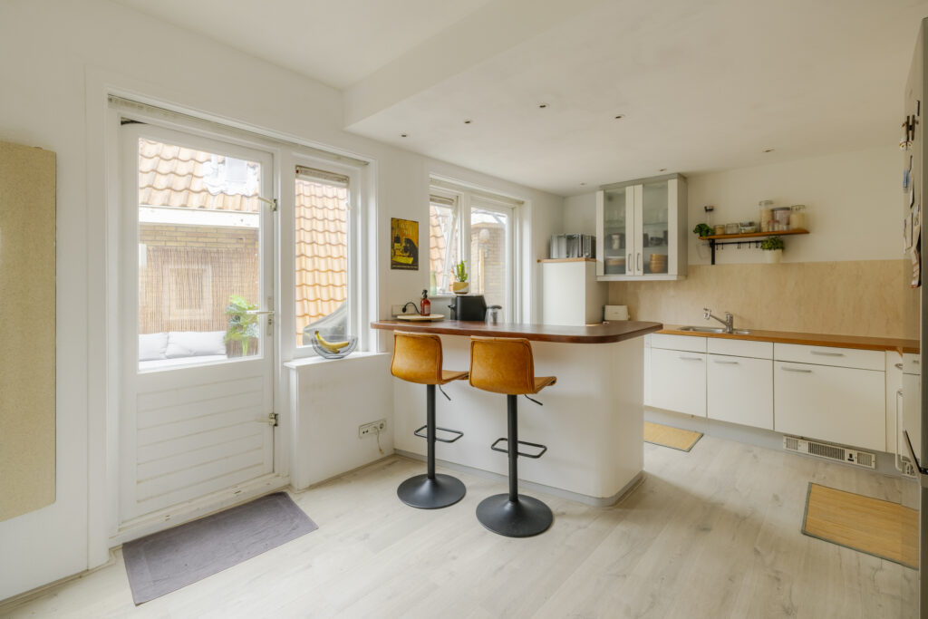 Modern kitchen with bar stools and natural light