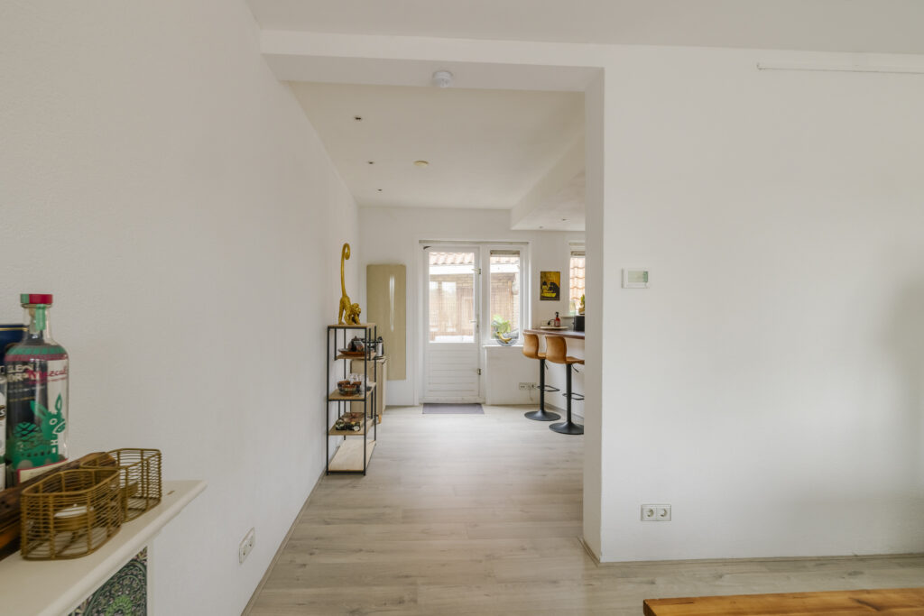 Modern kitchen with bar stools and patio door.
